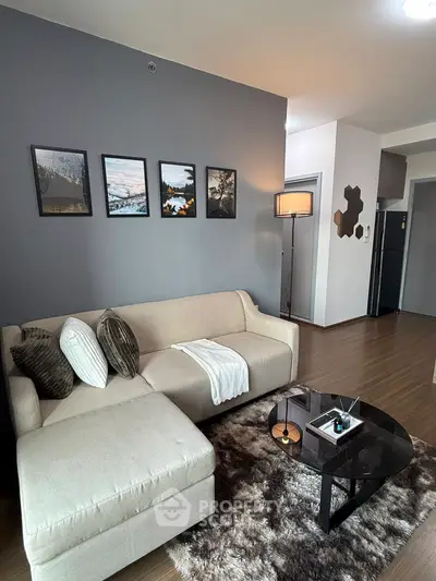 Modern living room with stylish decor, cozy sectional sofa, and elegant wall art in a contemporary apartment.