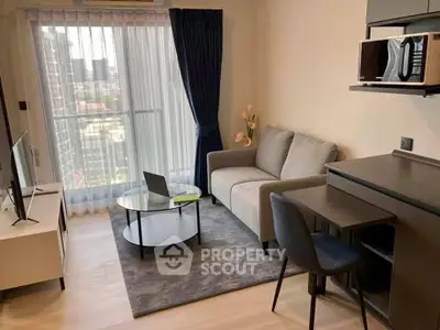 Modern living room with city view, featuring cozy sofa, sleek furniture, and large window for natural light.