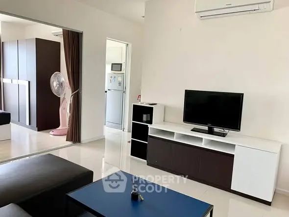 Modern living room with sleek furniture and air conditioning in a stylish apartment.