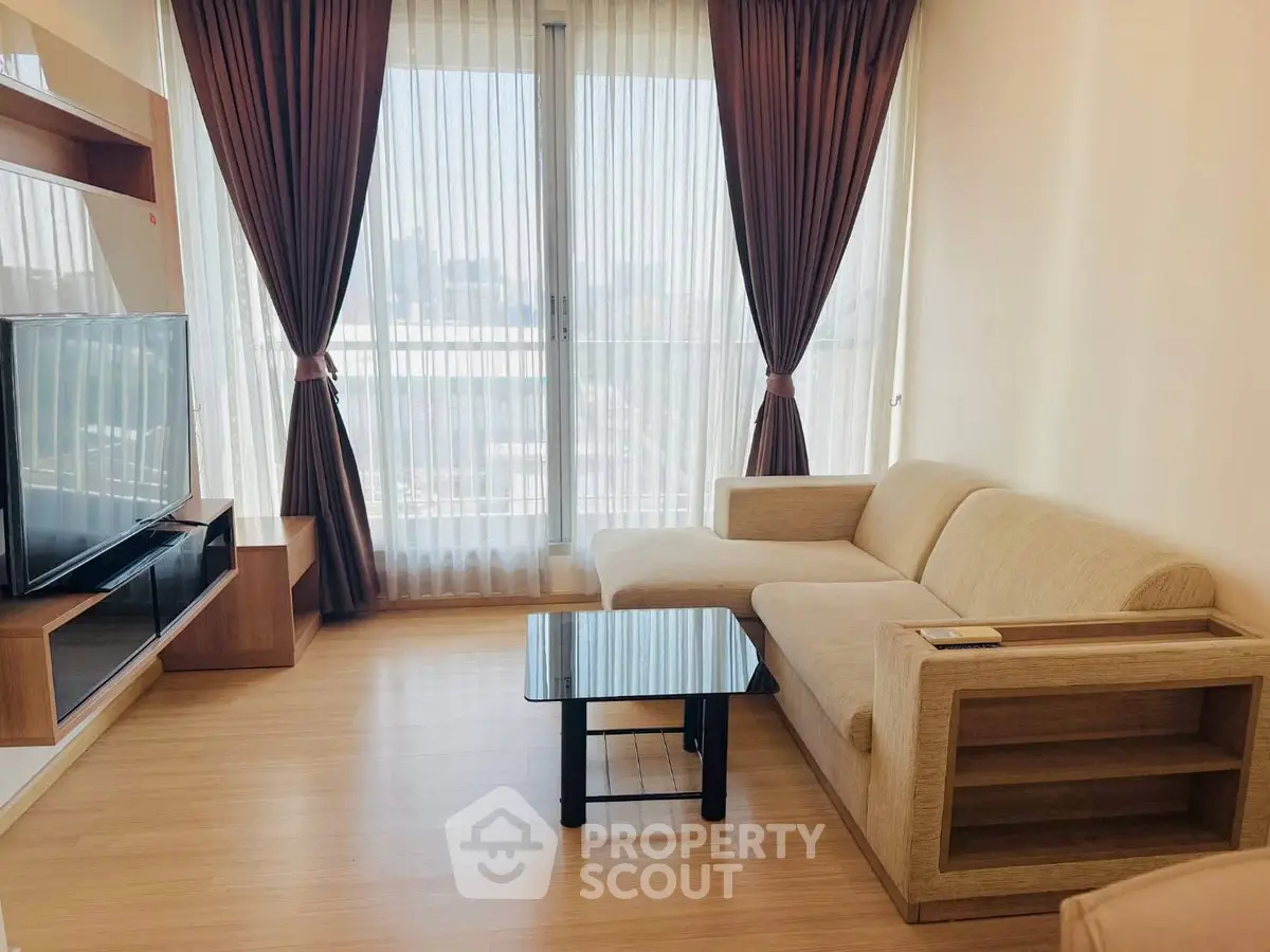 Modern living room with beige sofa and large window view
