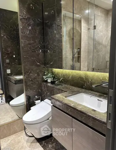 Luxurious modern bathroom with elegant marble finishes and sleek fixtures.