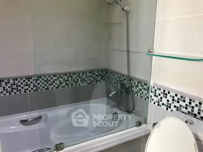 Modern bathroom with sleek bathtub and stylish tile accents