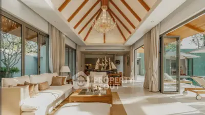 Luxurious living room with high ceilings, elegant chandelier, and pool view in modern villa.