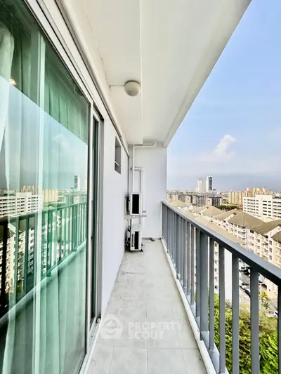 Spacious balcony with stunning city view in modern high-rise apartment