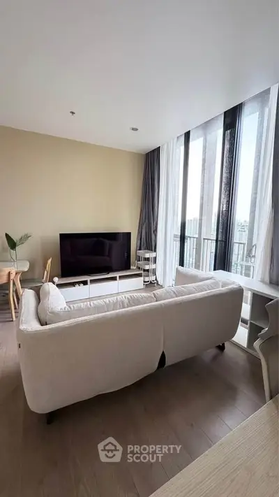Spacious modern living room with large windows and elegant decor