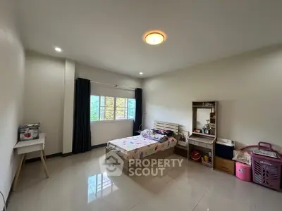 Spacious bedroom with modern decor and natural light