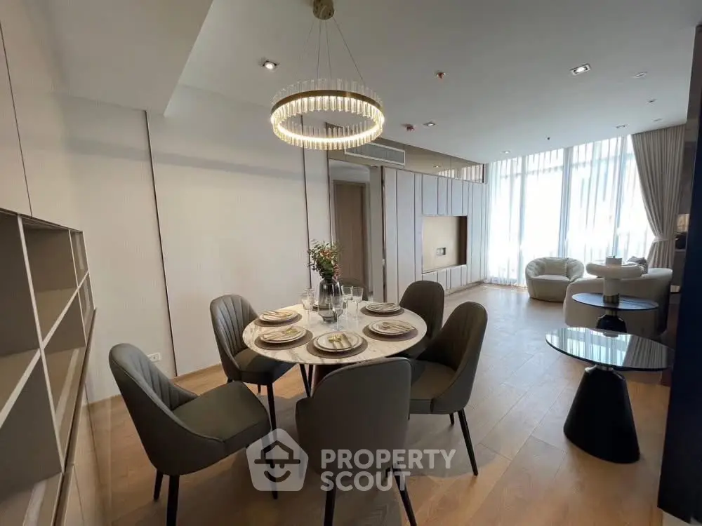 Modern dining area with elegant lighting and stylish furniture in a spacious living room.