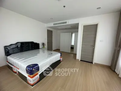 Spacious bedroom with modern decor and large bed in a bright apartment.