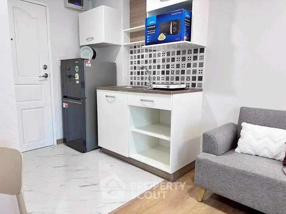 Modern compact kitchen with sleek appliances and stylish backsplash