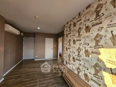 Chic urban-themed living space with eye-catching New York wallpaper and sleek wooden flooring, perfect for modern city living.