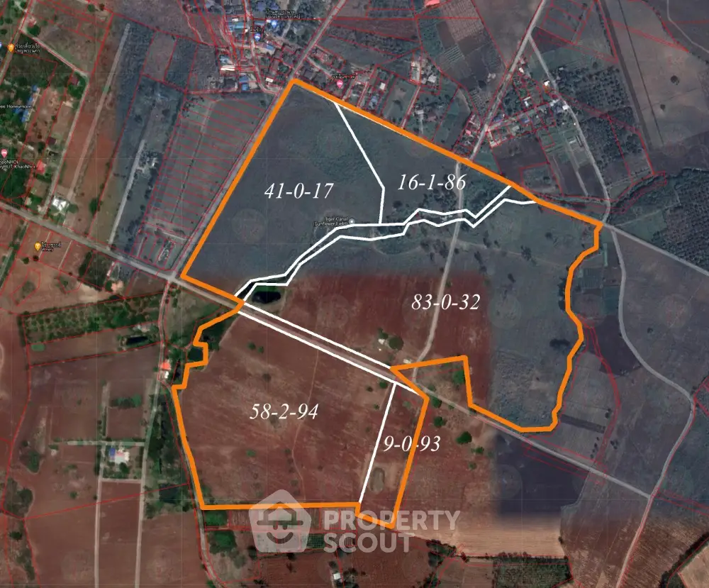 Aerial view of land plots with boundaries and numbers marked for real estate development.