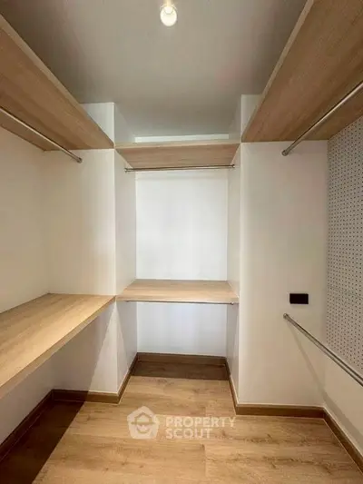 Spacious walk-in closet with wooden shelves and modern design