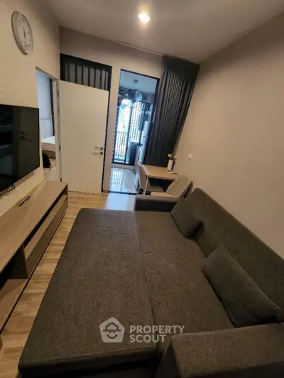 Modern living room with stylish sofa and wall-mounted TV in cozy apartment