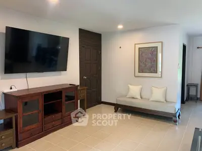 Spacious living room with modern TV setup and elegant decor