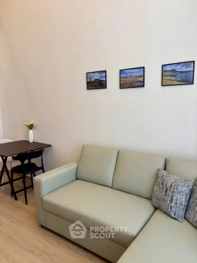 Modern living room with stylish sofa and wall art in cozy apartment