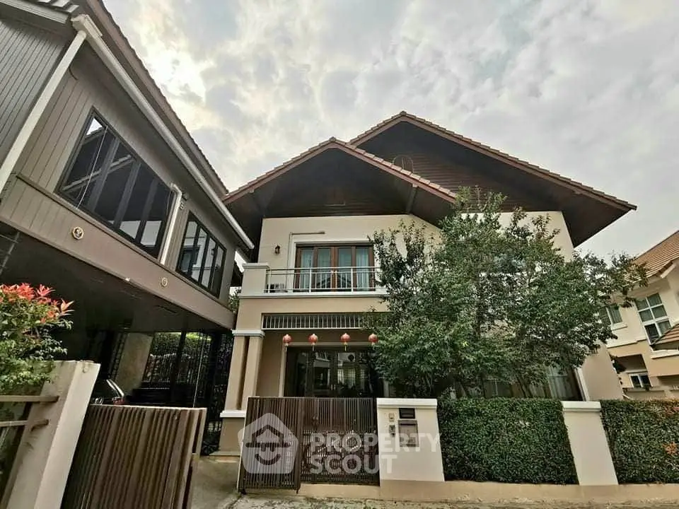 Charming two-story house with a lush garden and modern facade in a serene neighborhood.