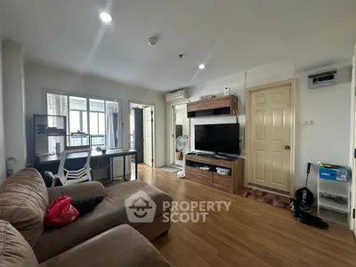 Cozy living room with modern furniture and wooden flooring in a stylish apartment.