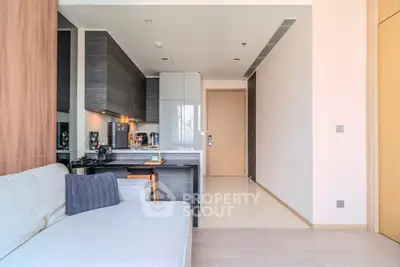 Modern open-layout kitchen and living room with sleek design and neutral tones.