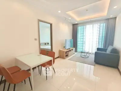 Modern living room with sleek furniture and large windows in a stylish apartment.