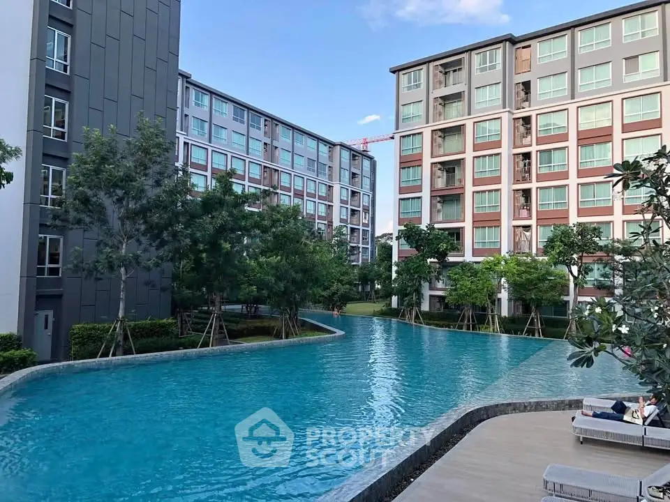 Luxurious apartment complex with stunning pool and modern architecture.