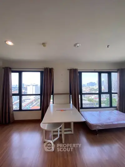 Spacious corner unit with stunning city views, featuring large windows and modern furnishings.