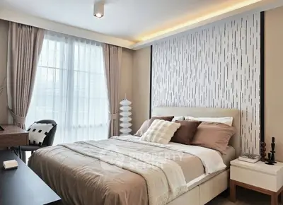 Elegant bedroom with modern decor and large window for natural light.