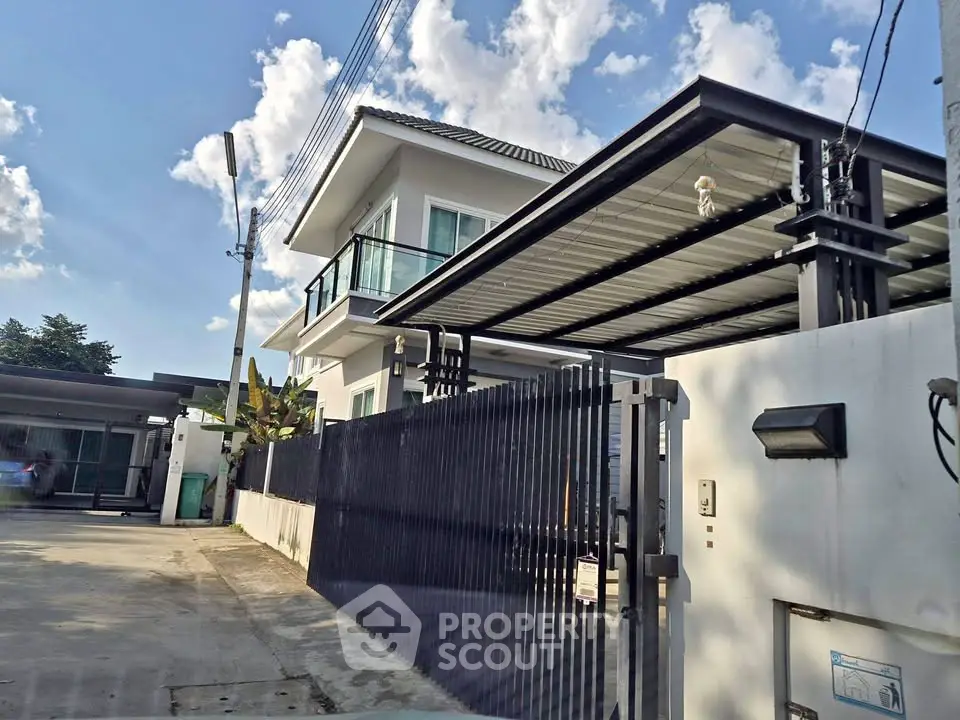 Modern two-story house with sleek design and spacious driveway under a clear blue sky.