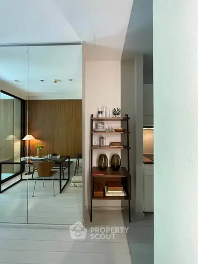 Modern living room with stylish decor and glass partition, showcasing contemporary design.