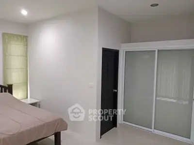 Modern bedroom with sleek sliding closet doors and minimalist decor