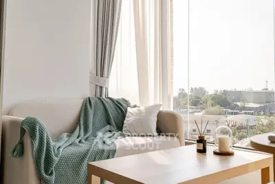 Bright and cozy living room with large windows and stylish decor