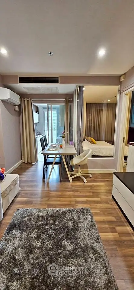 Modern apartment interior with open layout, featuring cozy living area and stylish dining space.