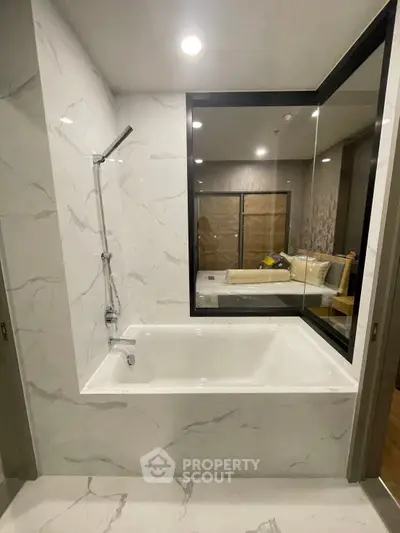 Luxurious bathroom with modern bathtub and elegant marble finish, perfect for relaxation and comfort.