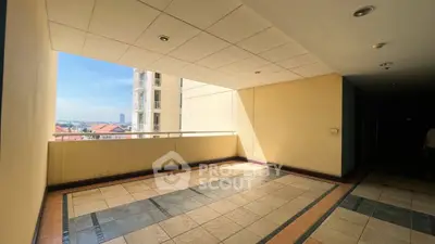 Spacious balcony with city view in modern apartment building