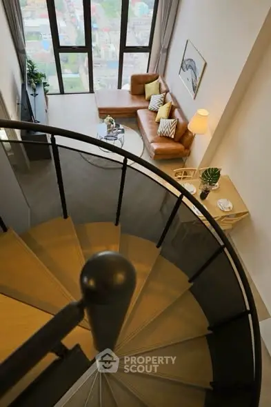 Stunning spiral staircase leading to a chic living room with city views.
