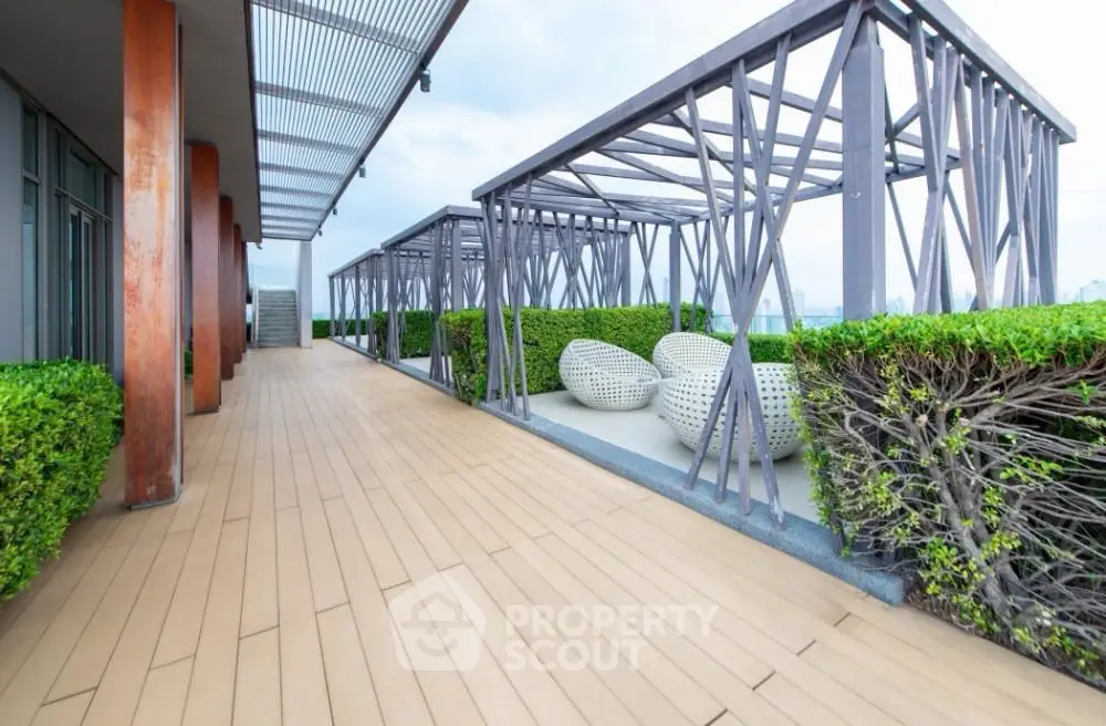 Luxurious rooftop terrace with modern seating and lush greenery, perfect for relaxation and city views.