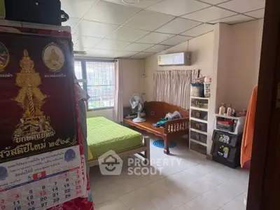 Cozy bedroom with air conditioning and organized storage in a well-lit space.