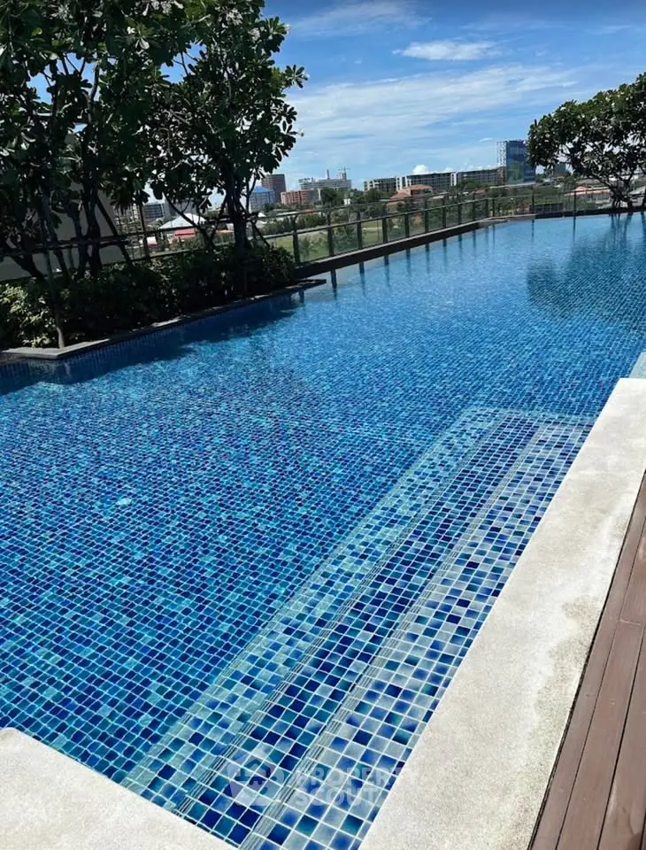 Luxurious rooftop infinity pool with stunning city views and lush greenery.