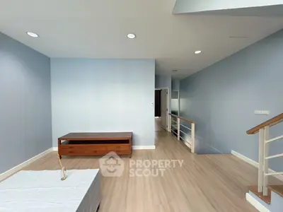 Spacious modern living room with wooden flooring and minimalist furniture