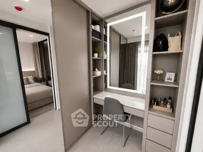 Modern bedroom with stylish vanity and ample storage in a contemporary apartment.