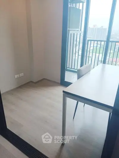 Modern study room with balcony view in high-rise apartment