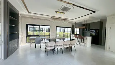 Spacious modern dining area with elegant chandelier and open kitchen layout
