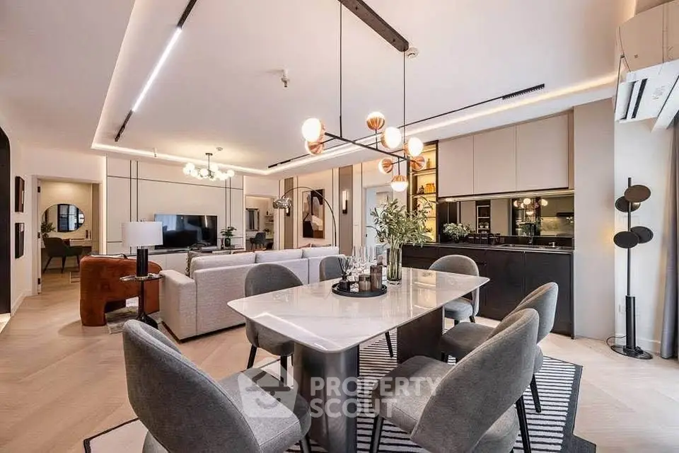 Luxurious open-plan living and dining area with modern decor and elegant lighting.
