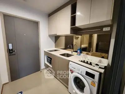 Modern compact kitchen with washing machine and sleek cabinetry