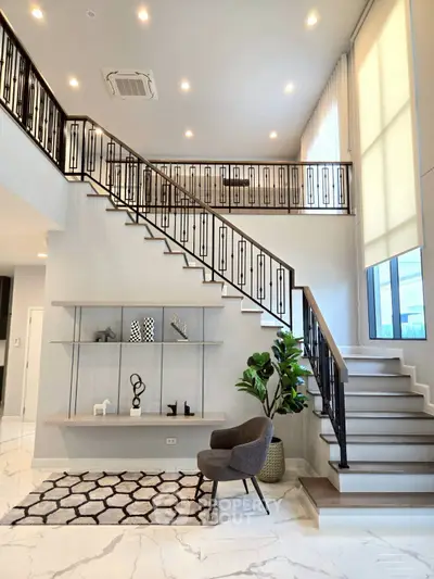 Elegant modern living room with stylish staircase and chic decor