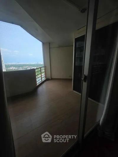 Spacious balcony with stunning city view in modern high-rise apartment.