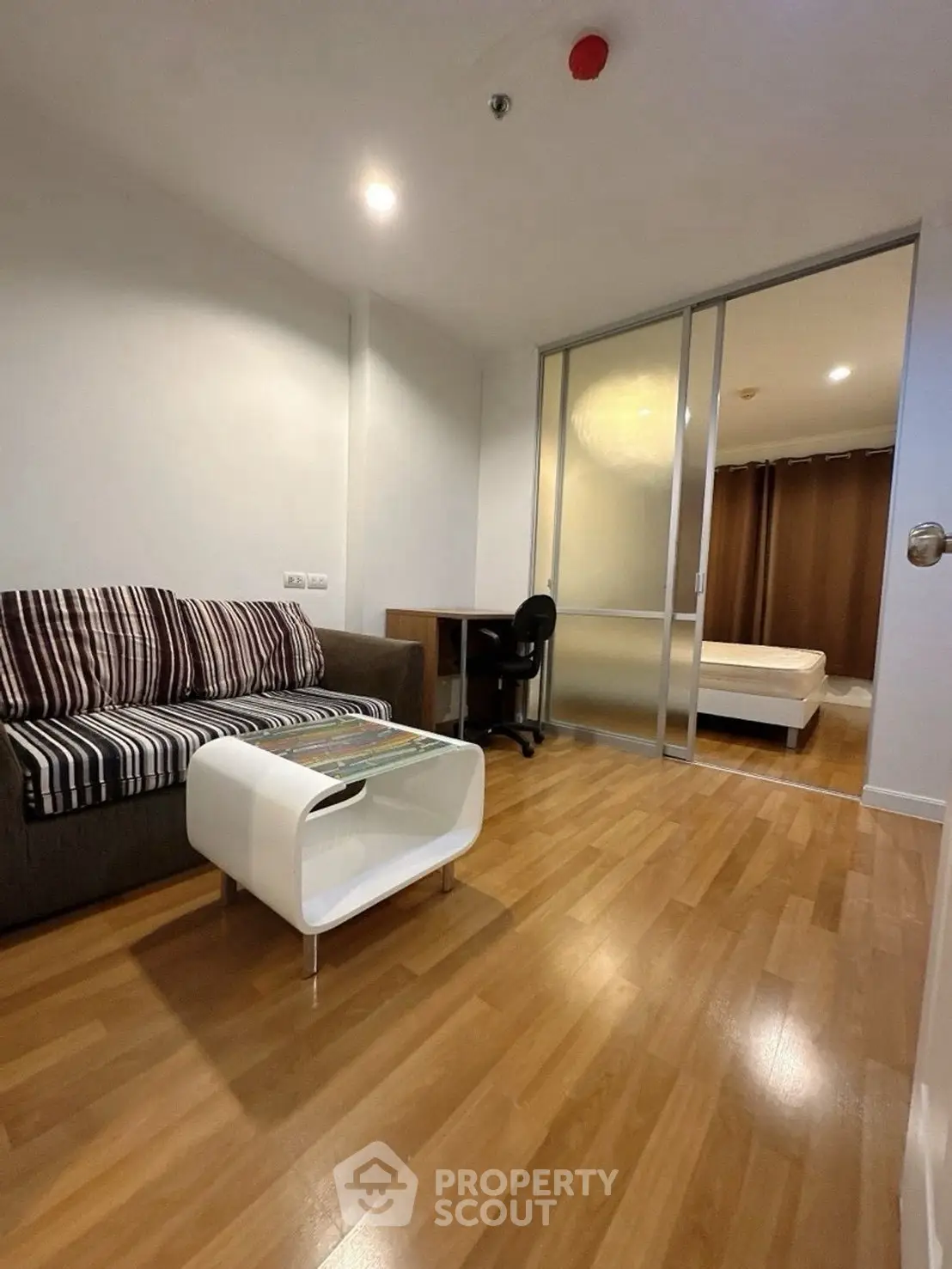 Modern apartment with cozy living room and sliding door to bedroom