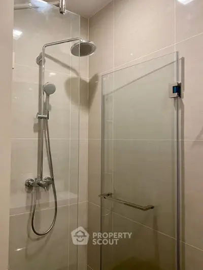 Modern bathroom with sleek shower design and glass door enclosure.