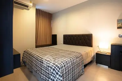 Cozy bedroom with modern decor and ambient lighting, featuring a comfortable bed and stylish furnishings.