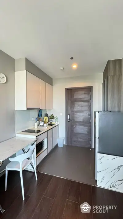 Modern kitchen with sleek cabinetry and marble accents in stylish apartment