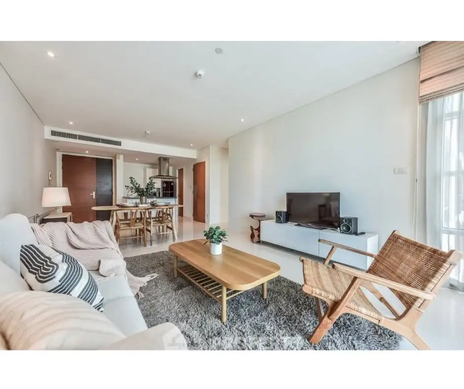Spacious modern living room with stylish furniture and open kitchen layout.